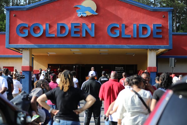 Faith leaders and community members gather Thursday for a stop the violence march and prayer outside of the Golden Glide skating rink.