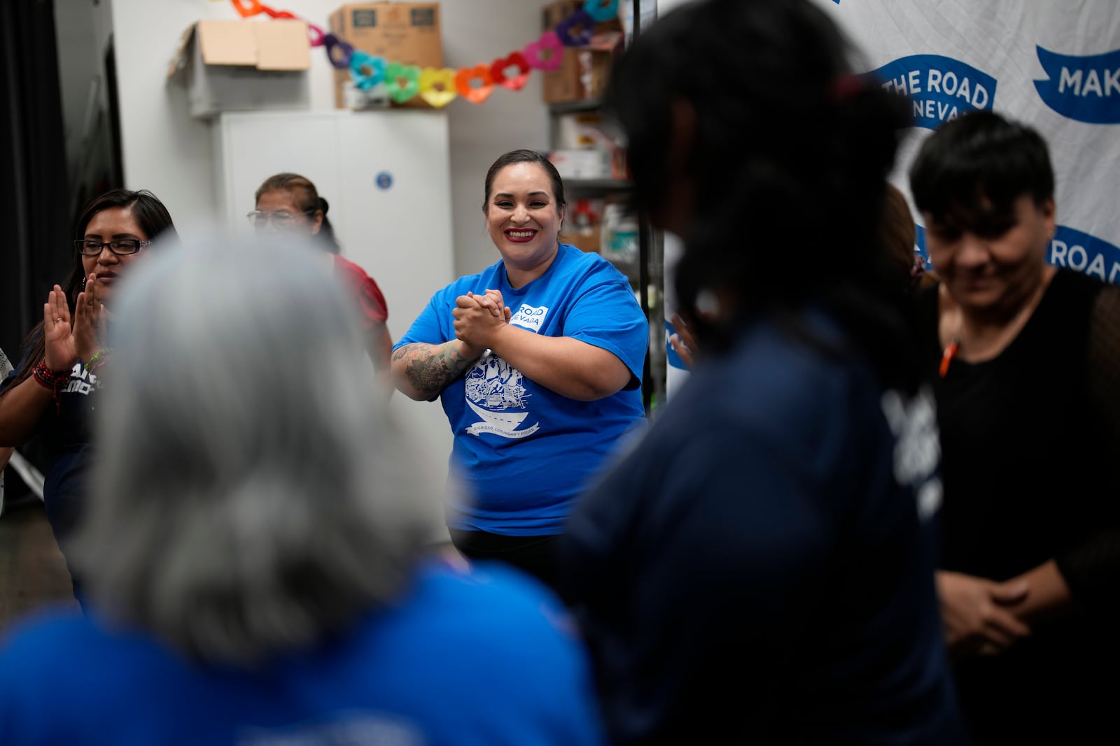 Erika Marquez, center, leads a meeting at the nonprofit Make the Road Nevada, where she works as the immigration and justice organizer, Thursday, Sept. 12, 2024, in Las Vegas. Marquez is a recipient of an Obama administration amnesty for immigrants brought to the U.S. illegally as children. (AP Photo/John Locher)