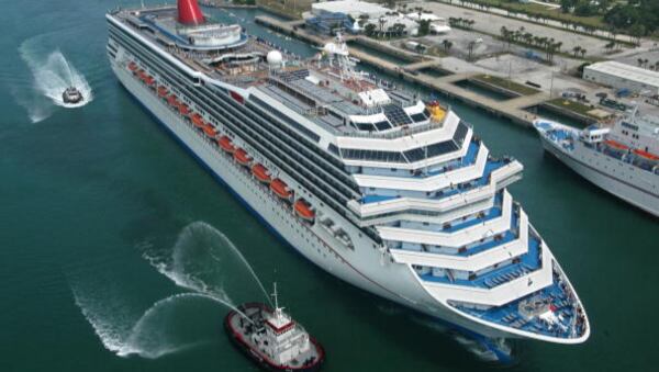 File photo: Escorted by water-squirting tugs, the  Carnival Glory arrives July 11, 2003 in Cape Canaveral, Florida.