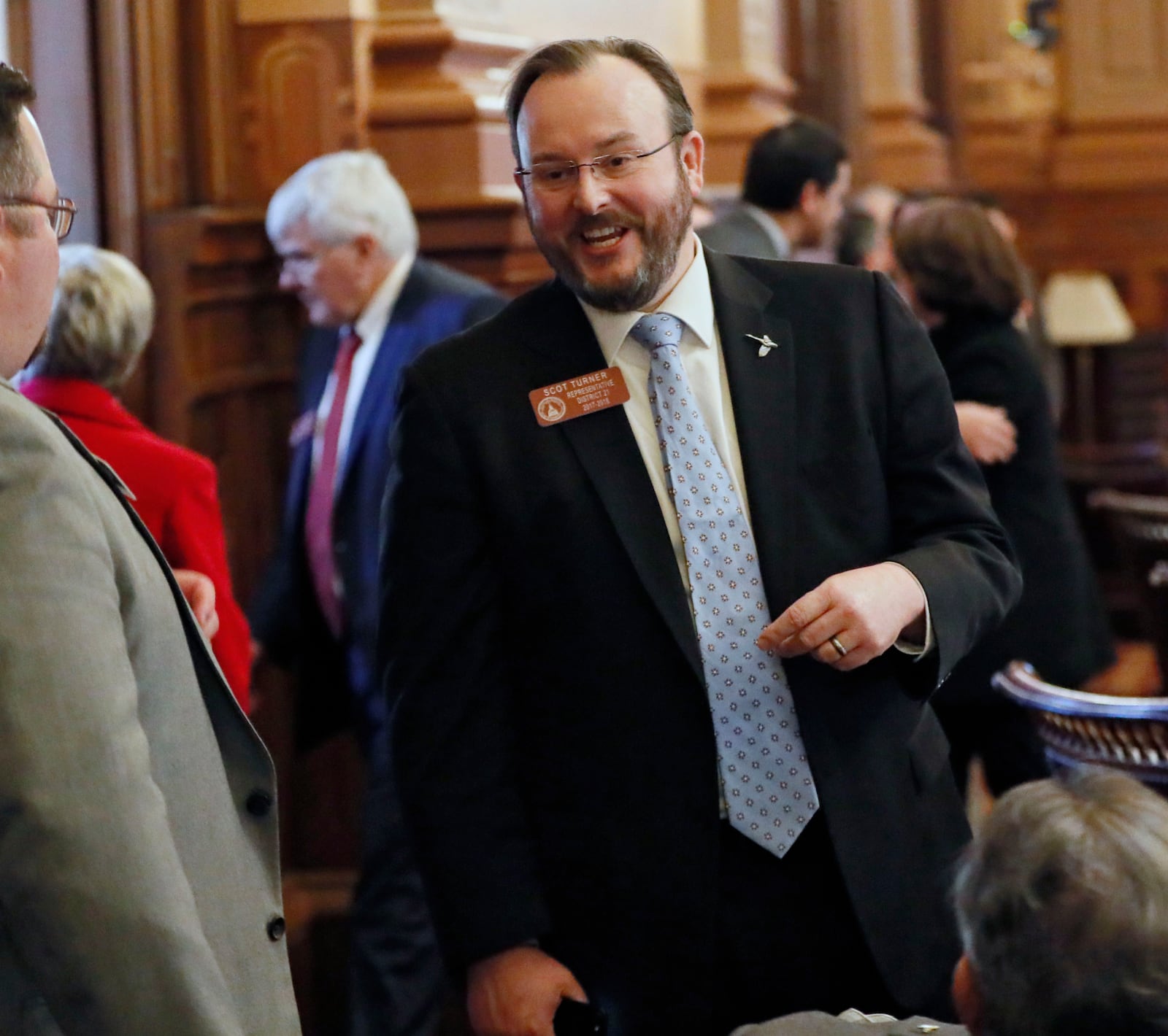 FILE - Rep. Scot Turner, R - Holly Springs, confers with colleagues on the floor of the Georgia State House in Atlanta, Feb. 8, 2018. (Bob Andres/Atlanta Journal-Constitution via AP, File)