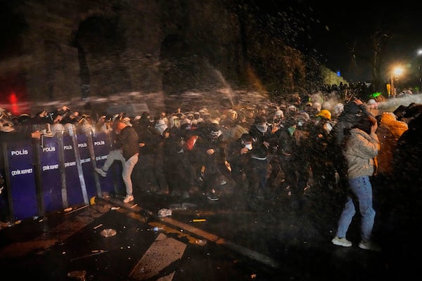 Police officers use pepper spray during clashes with people as they protest against the arrest of Istanbul's Mayor Ekrem Imamoglu, in Istanbul, Turkey, Friday, March 21, 2025. (AP Photo/Khalil Hamra)