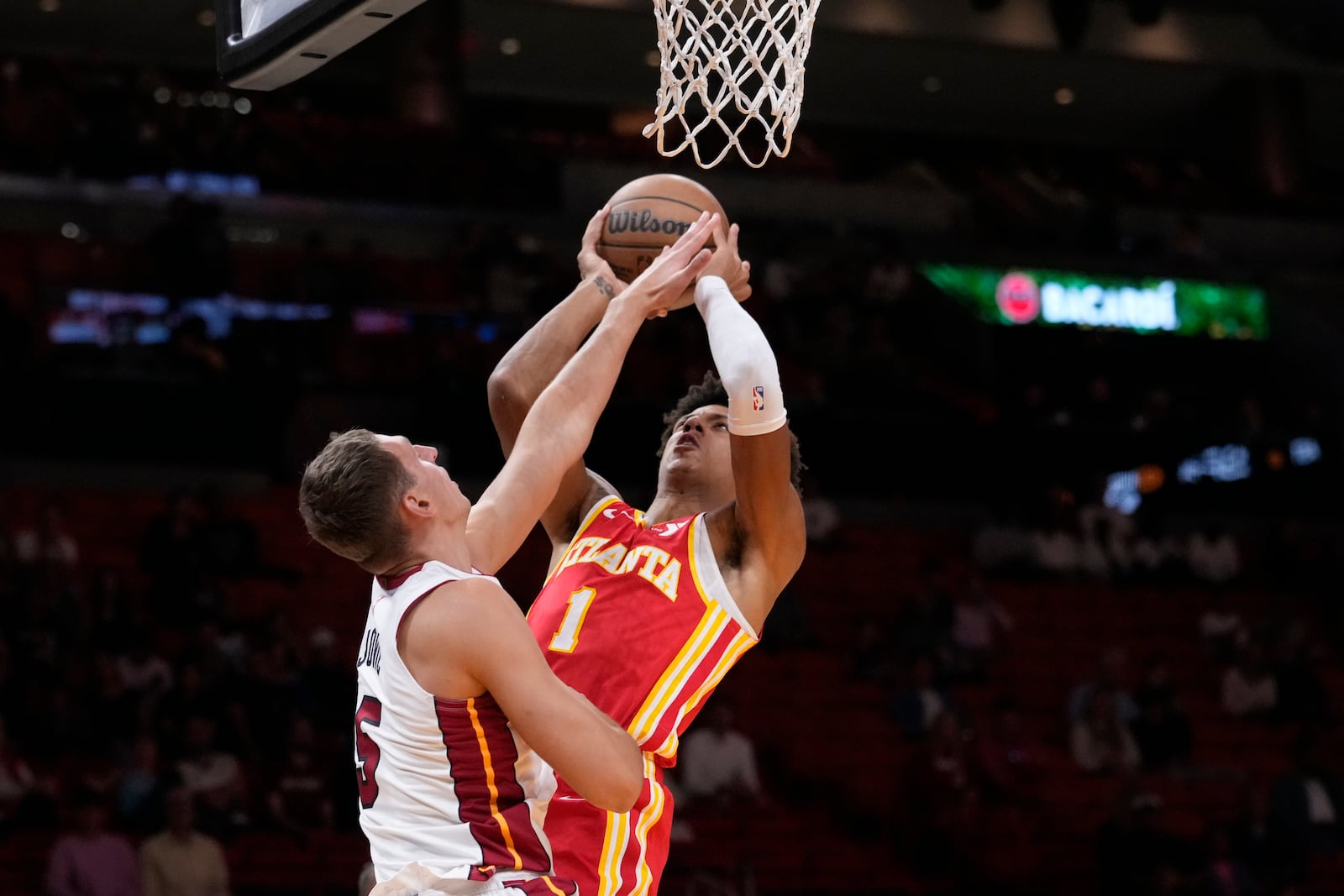 Atlanta Hawks forward Jalen Johnson (1) goes up for a shot against Miami Heat forward Nikola Jovic (5) during the first half of an NBA preseason basketball game, Wednesday, Oct. 16, 2024, in Miami. (AP Photo/Wilfredo Lee)