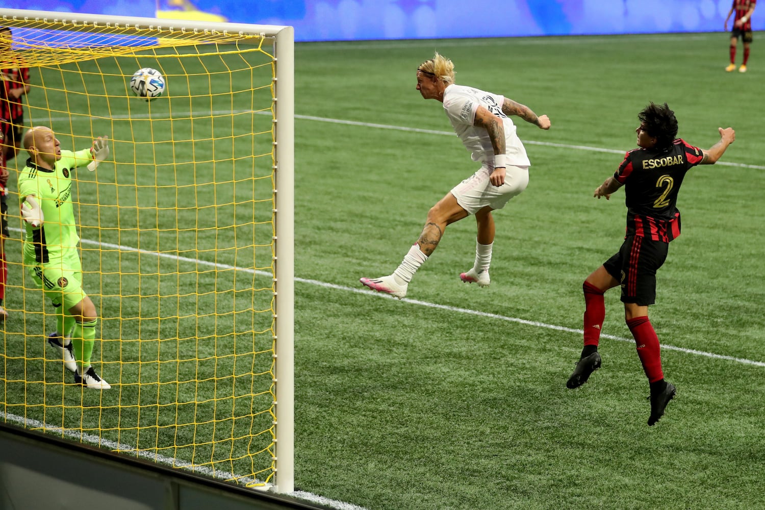 Miami defender Break Shea (28) heads a goal against Atlanta United goalkeeper Brad Guzan, left, and defender Franco Escobar (2). JASON GETZ FOR THE ATLANTA JOURNAL-CONSTITUTION