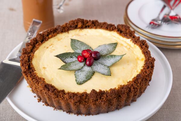 A couple of star ingredients, like tangy buttermilk and a hint of mandarin orange zest, bring elegance to this Buttermilk Cheesecake Tart with Gingerbread Crust adorned with homemade sugared bay leaves. (Courtesy of Brooke Slezak)