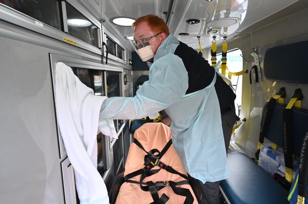 AJC photographer Hyosub Shin has covered scenes from the coronavirus pandemic in metro Atlanta and Georgia. In this March 18 photo, Stephen Tucker wears protective gear as he cleans out an ambulance at AmeriPro EMS in Riverdale. (Photo: Hyosub Shin / Hyosub.Shin@ajc.com)