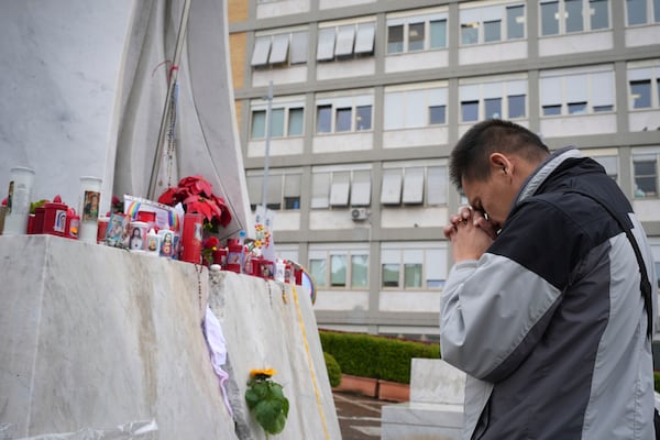 Hoang Phuc Nguyen, a Vietnamese pilgrim, prays for Pope Francis at the Agostino Gemelli Polyclinic, in Rome, Tuesday, Feb. 25, 2025 where Pope Francis is hospitalised since Friday, Feb. 14. (AP Photo/Alessandra Tarantino)