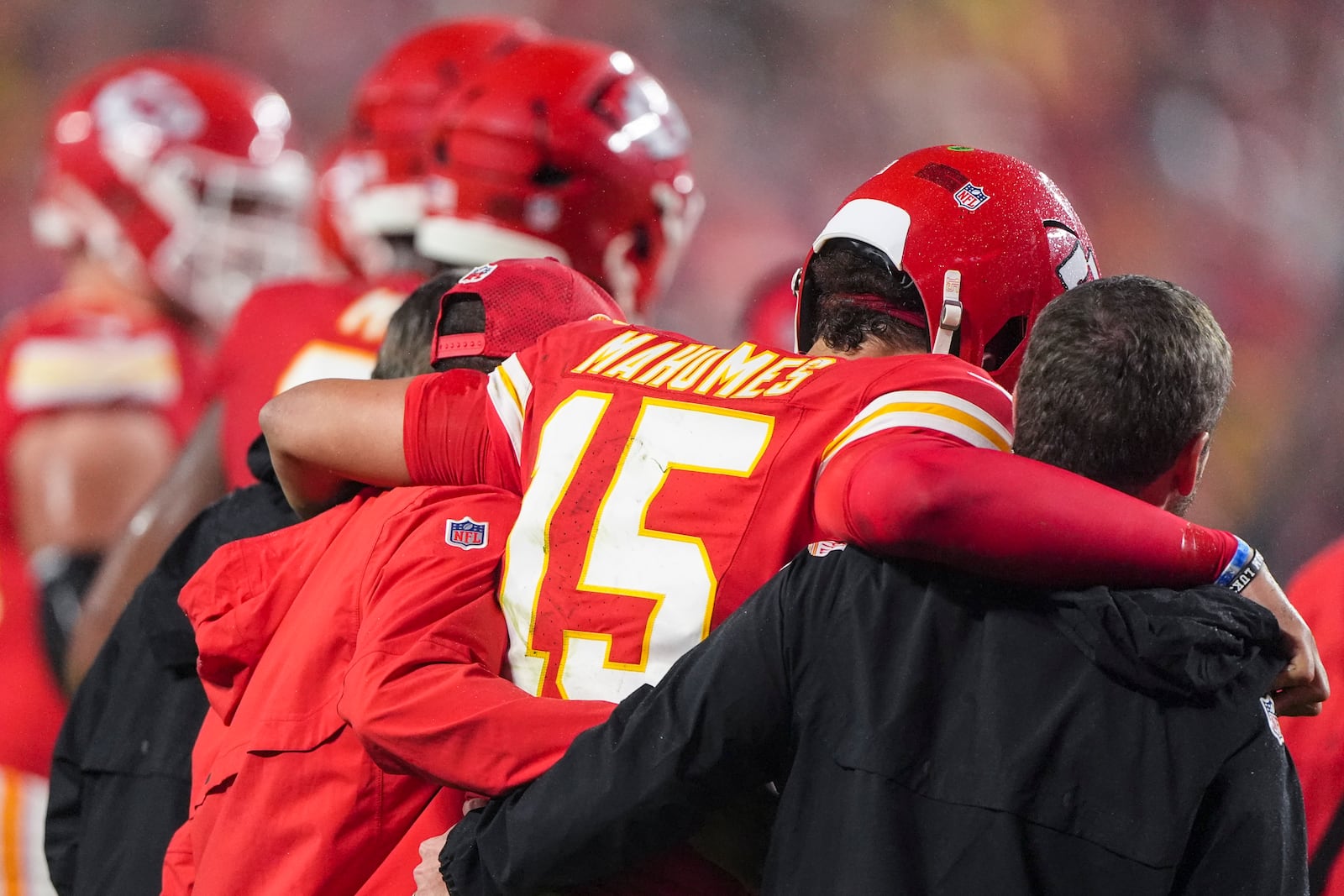 Kansas City Chiefs quarterback Patrick Mahomes (15) is helped off the field after injury against the Tampa Bay Buccaneers during the second half of an NFL football game, Monday, Nov. 4, 2024, in Kansas City, Mo. (AP Photo/Charlie Riedel)