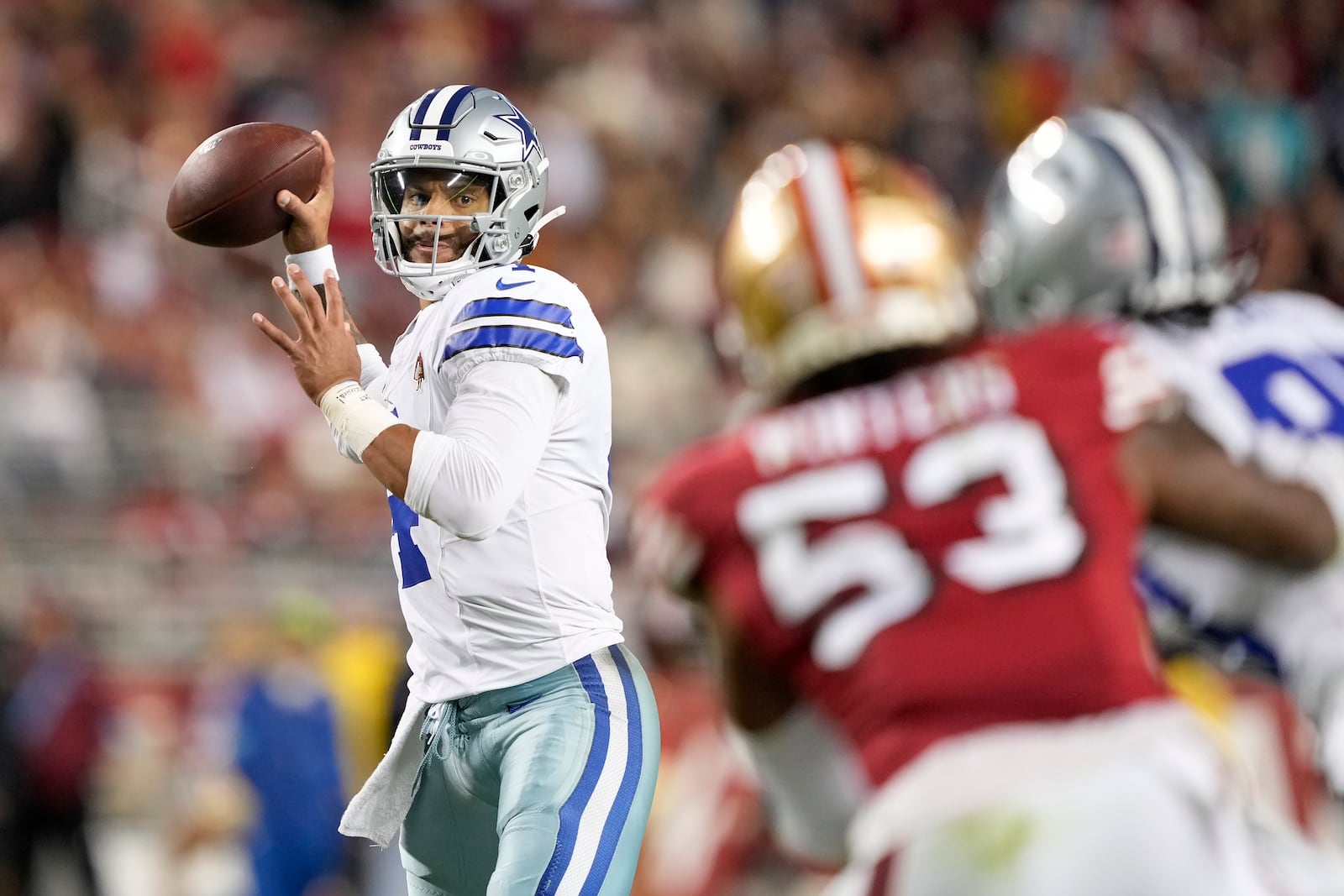 Dallas Cowboys quarterback Dak Prescott, left, passes against the San Francisco 49ers during the first half of an NFL football game in Santa Clara, Calif., Sunday, Oct. 27, 2024. (AP Photo/Tony Avelar)