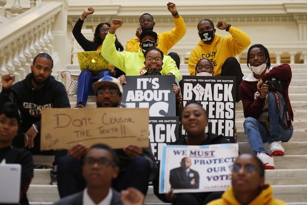 A group of protesters sits on the south side of the Georgia Capitol waiting on House Bill 1464 to come to the floor Tuesday. The bill would allow anyone to inspect original paper ballot and empower the GBI to intervene in fraud investigations. Miguel Martinez for The Atlanta Journal-Constitution 