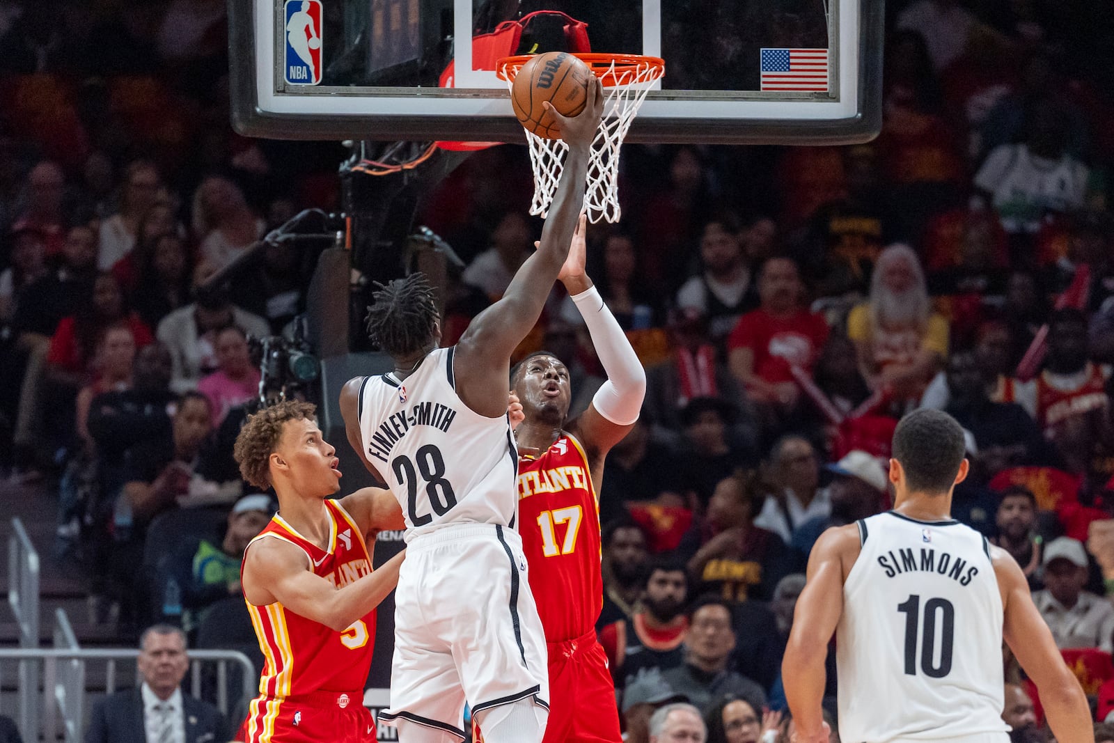 Brooklyn Nets forward Dorian Finney-Smith (28) shoots over Atlanta Hawks forward Mouhamed Gueye (18) during the first half of an NBA basketball game, Wednesday, Oct. 23, 2024, in Atlanta. (AP Photo/Jason Allen)