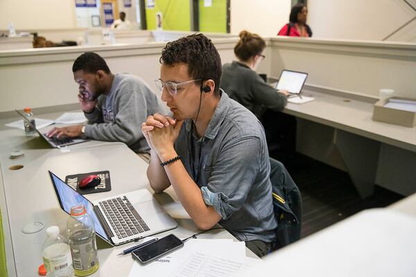 A staff worker with the Stacey Abrams campaign on the phone with voters on Friday, aggressive provisional ballot chase. ALYSSA POINTER/ALYSSA.POINTER@AJC.COM