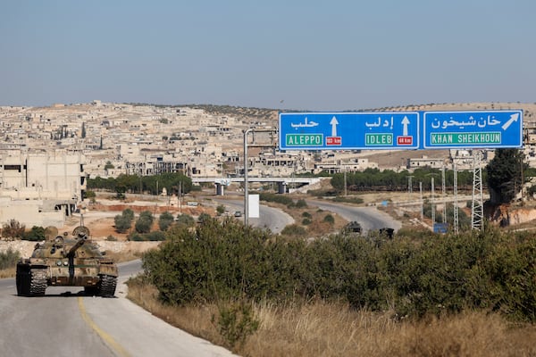 An abandoned Syrian army armoured vehicle sits on a highway in the outskirts of in Khan Sheikhoun, southwest of Aleppo, Sunday, Dec. 1, 2024. Syrian opposition insurgency launched a campaign on Wednesday with a two-pronged attack on Aleppo and the countryside around Idlib.(AP Photo/Ghaith Alsayed)