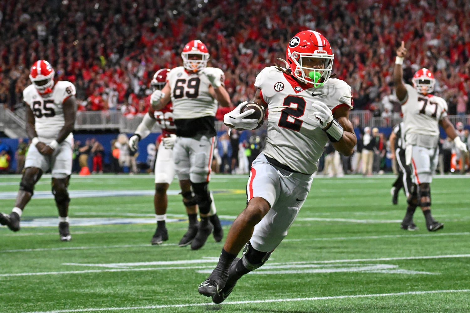 Georgia Bulldogs running back Kendall Milton (2) runs for a 17 yard touchdown against the Alabama Crimson Tide during the first half of the SEC Championship football game at the Mercedes-Benz Stadium in Atlanta, on Saturday, December 2, 2023. (Hyosub Shin / Hyosub.Shin@ajc.com)