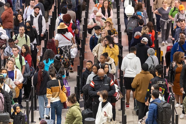 People gather in line at the Hartsfield-Jackson Atlanta International Airport on Monday, March 27, 2023. (Arvin Temkar / arvin.temkar@ajc.com)