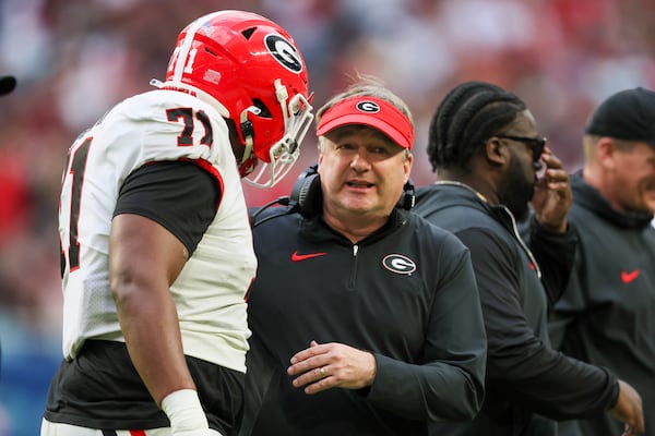 Georgia coach Kirby Smart (right) talks with offensive lineman Earnest Greene III during the Orange Bowl on Dec. 30, 2023, at Hard Rock Stadium in Miami Gardens, Florida. Georgia won 63-3 against Florida State. Jason Getz/AJC 2023