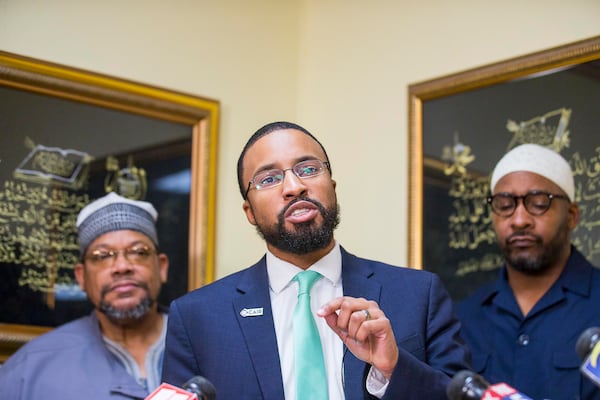 Executive director of CAIR Georgia, Edward Ahmed Mitchell, (center) speaks during a press conference at the Masjid Al-Mu'minun mosque in Atlanta's Peoplestown neighborhood, Friday, March 15, 2019. 