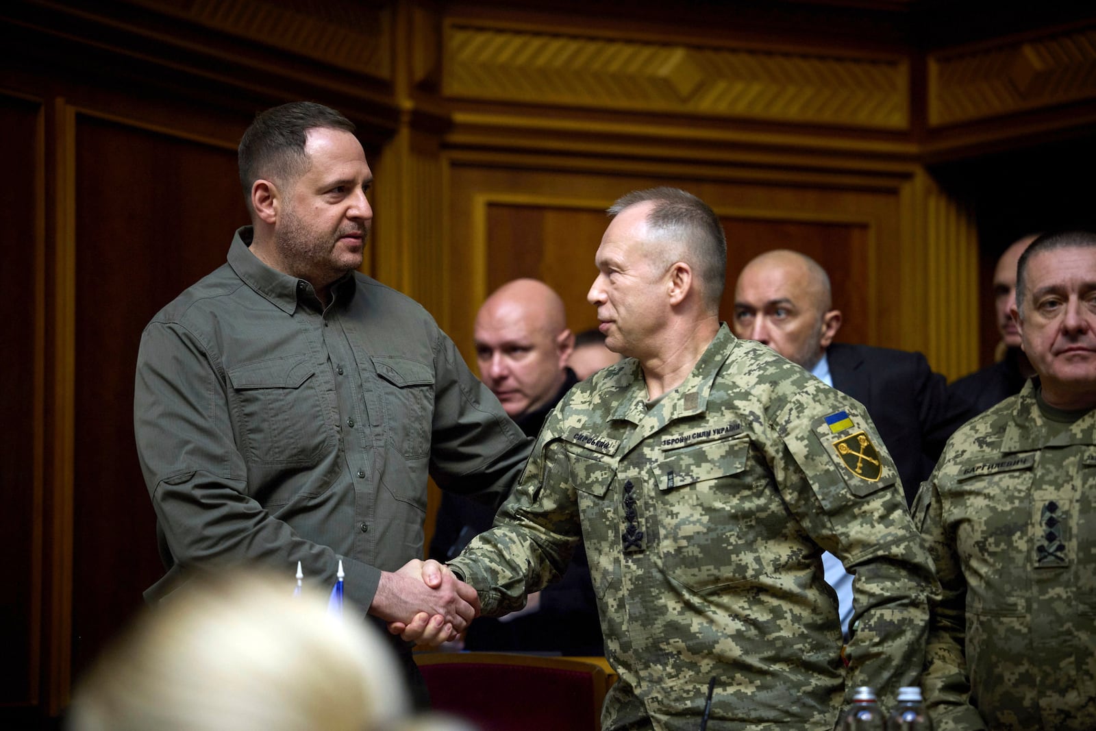 In this photo provided by the Press Service Of The President Of Ukraine on Oct. 16, 2024, Head of Ukrainian Presidential Office Andriy Yermak, left, shakes hand with Commander-in-Chief of the Armed Forces of Ukraine General Oleksandr Syrskyi at Verkhovna Rada in Kyiv, Ukraine. (Press Service Of The President Of Ukraine via AP)