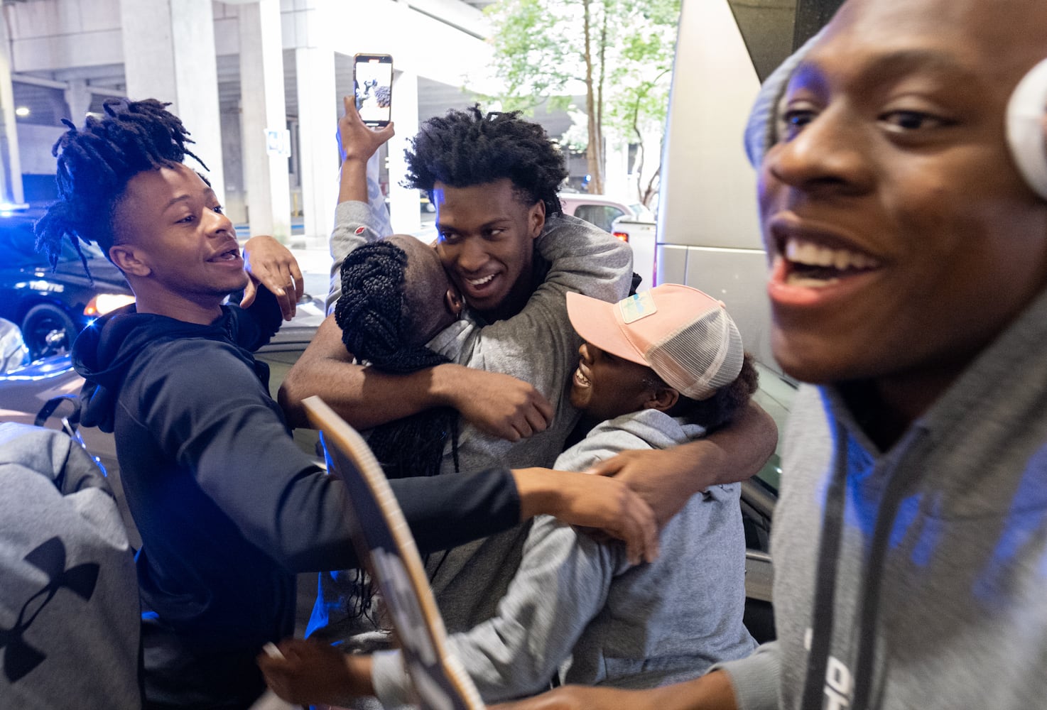 220308-Atlanta-Jamall Clyce, center, celebrates with family and friends after the Georgia State University basketball team returned home Tuesday, March 8, 2022, after the team won the Sun Belt Conference championship. Ben Gray for The Atlanta Journal-Constitution