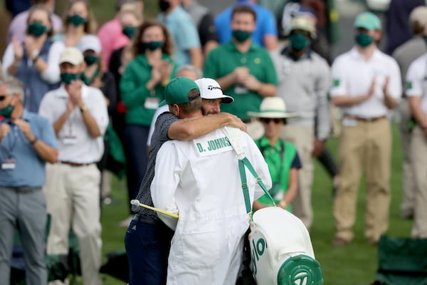 Dustin Johnson celebrates with his brother and caddie Austin Johnson on the 18th green winning the 2020 Masters Tournament Sunday, Nov. 15, 2020, at Augusta National. (Curtis Compton / Curtis.Compton@ajc.com)