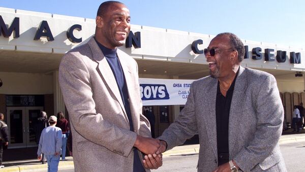 Former Macon high school great Terry Fair (left) has some happy moments with his former high school coach Don Richardson outside of Macon Coliseum just before the state playoffs in 1999. (W.A. Bridges Jr./AJC file photo)