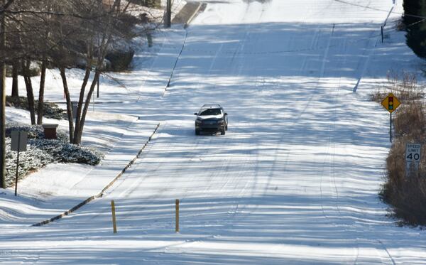 A motorist makes their way on an icy road in Snellville on Wednesday. HYOSUB SHIN / HSHIN@AJC.COM