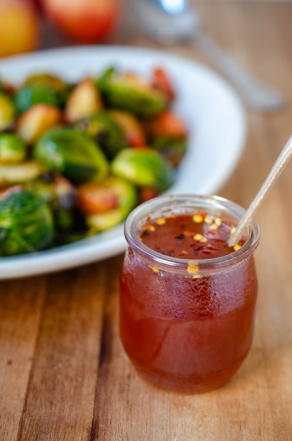 Apple Cider Hot Honey Reduction, shown here with Brussels sprouts and apples, is a sweet and spicy topping for a variety of winter vegetables. (Virginia Willis for The Atlanta Journal-Constitution)