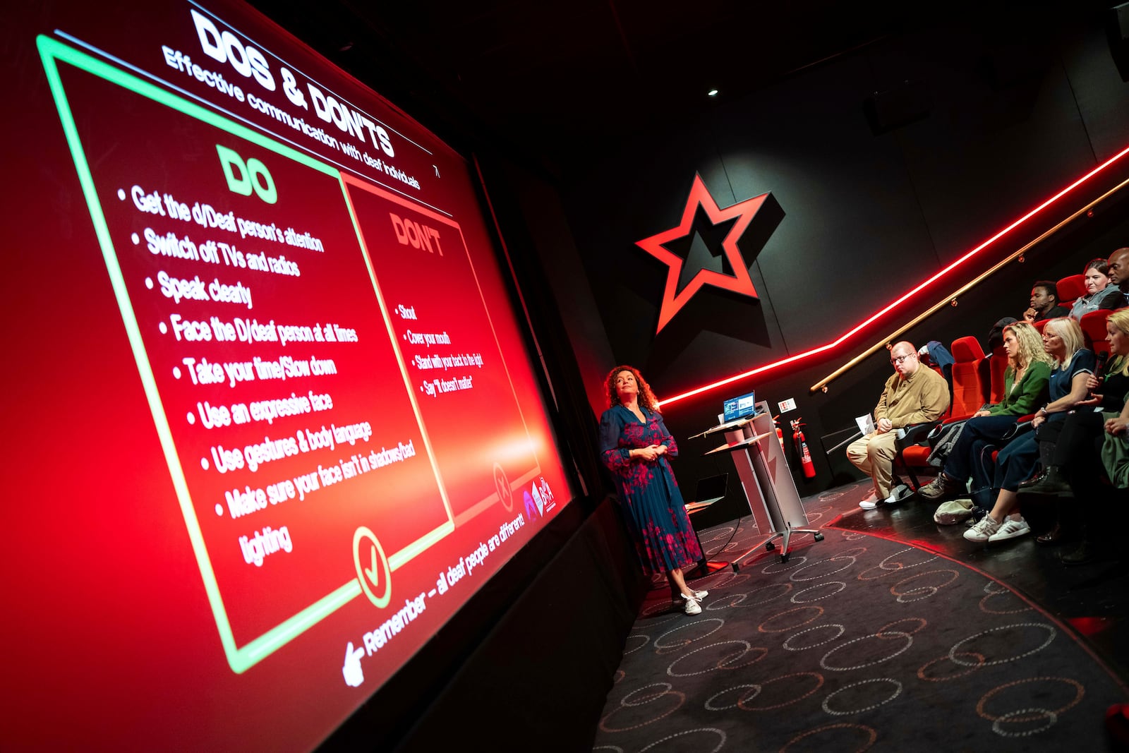 Yvonne Cobb, ambassador for the British Deaf Association, speaks to front of house cinema staff about deaf awareness training, on Wednesday, Oct. 2, 2024 in London.(Photo by Scott A Garfitt/Invision/AP)