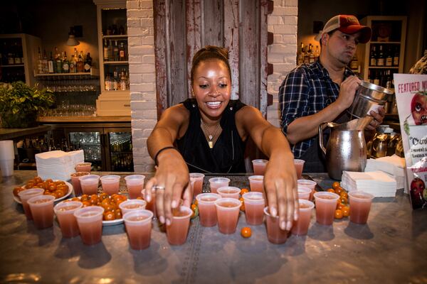 Kesha Bellamy sets out Cherokee Purple cocktails at JCT Kitchen and Bar during the 7th annual Attack of the Killer Tomato Festival at JCT Kitchen and Bar in Atlanta, Ga. Sunday July 19th.STEVE SCHAEFER / SPECIAL TO THE AJC