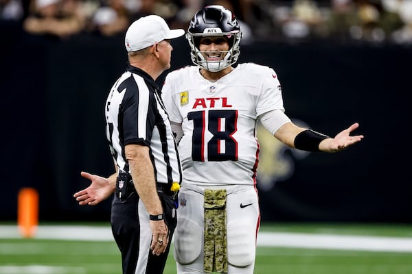 Atlanta Falcons quarterback Kirk Cousins (18) speaks with referee Carl Cheffers (51) during the second half of an NFL football game against the New Orleans Saints, Sunday, Nov. 10, 2024, in New Orleans. (AP Photo/Butch Dill)