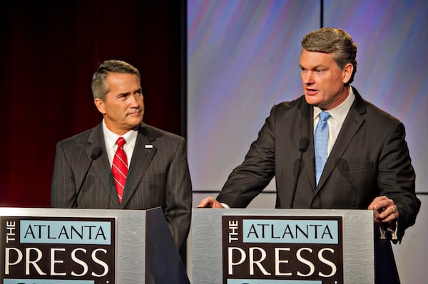 Jody Hice, left, and Mike Collins debate during their 2014 contest in the 10th Congressional District. Hice, who narrowly won that race, is now running for secretary of state, and Collins is currently the front-runner to replace him in a race with about a dozen contenders.