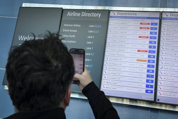 Cancellations for British Airways flights to London Heathrow airport are displayed as cancelled on a departures board at JFK International airport, Friday, March 21, 2025, in New York. (AP Photo/John Minchillo)