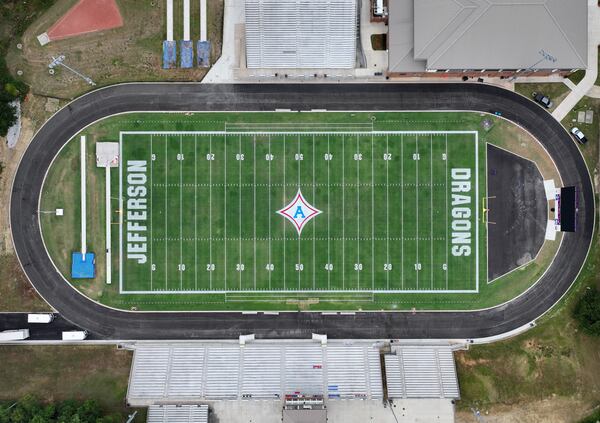 A big “A” logo has been painted on the 50-yard line for a tribute to Apalachee High School ahead of Jefferson High School’s home football game against Stephens County at Jefferson Memorial Stadium, Friday, Sept. 6, 2024, in Jefferson. (Hyosub Shin / AJC)