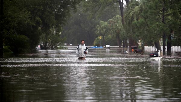 Joey Spalding walks back to his truck down the street where he lives, Monday, Sept. 11, 2017, on Tybee Island, Ga. Spalding just finished repairing his house from nine inches of water after Hurricane Matthew passed the island last year. He said the Tropical Storm Irma brought three feet of storm surge into his living room today. (AP Photo/Stephen B. Morton)