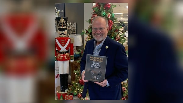 Glynn County Commissioner David Sweat shows off his book.