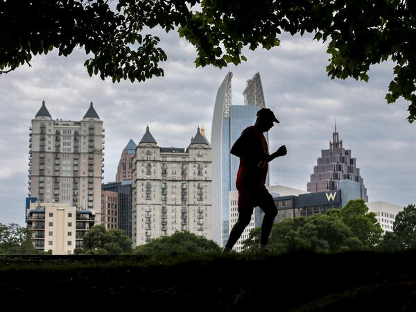 Von Gaston beat the afternoon rain by getting in his twice-a-week, 5-mile run at Piedmont Park. JOHN SPINK / JSPINK@AJC.COM