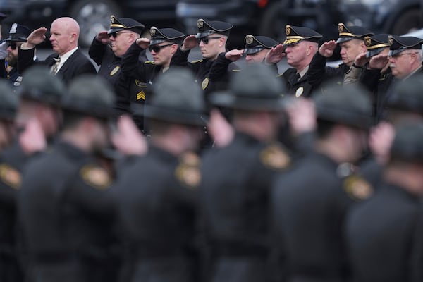 Officers salute the procession as the remains of West York Borough Police Officer Andrew Duarte, arrive for his funeral at Living Word Community Church, in Red Lion, Pa., Friday, Feb. 28, 2025. (AP Photo/Matt Rourke)