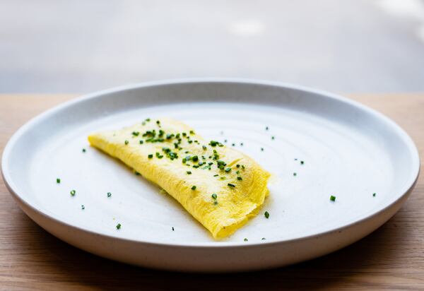 A classic French omelet prepared by chef Nick Leahy at Aix. CONTRIBUTED BY HENRI HOLLIS