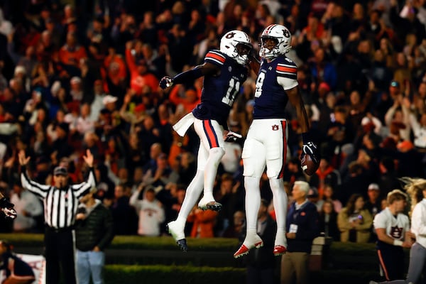 Auburn wide receiver Cam Coleman (8) celebrates with Auburn wide receiver Malcolm Simmons (11) after scoring a touchdown against Texas A&M during the first half of an NCAA college football game, Saturday, Nov. 23, 2024, in Auburn, Ala. (AP Photo/Butch Dill)