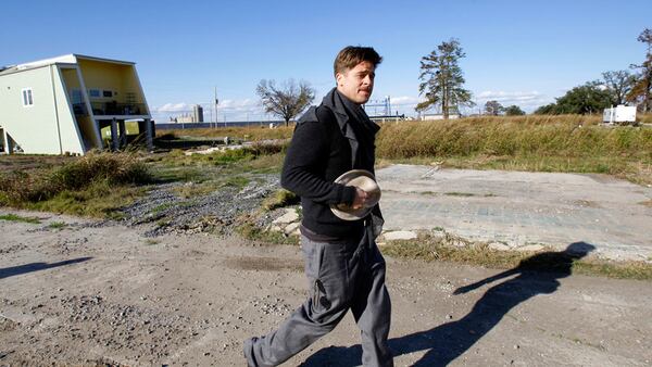 FILE - In this Dec. 1, 2008, file photo, Brad Pitt walks in the Lower 9th Ward between a home built by the Make It Right Foundation and a FEMA trailer in New Orleans. An attorney is suing Pitt’s foundation over the degradation of homes built in an area of New Orleans that was among the hardest hit by Hurricane Katrina.