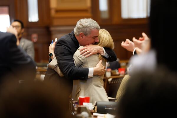 Democratic state Rep. Esther Panitch of Sandy Springs and Republican state Rep. John Carson of Marietta, embrace Monday after House Bill 30 won passage in the House. They were some of the authors of the bill, which would define antisemitism so that it could be covered under Georgia's hate crimes law. Miguel Martinez /miguel.martinezjimenez@ajc.com