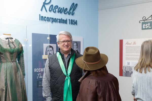 Kevin Bamford, president of the Roswell Historical Society talks to a visitor during the opening of the new museum.  (Natrice Miller/natrice.miller@ajc.com)  