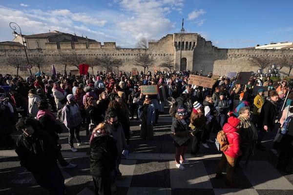 Activists gather during a women's rights demonstration, Saturday, Dec. 14, 2024 in Avignon, southern France, where the trial of dozens of men accused of raping Gisèle Pelicot while she was drugged and rendered unconscious by her husband is taking place. (AP Photo/Aurelien Morissard)