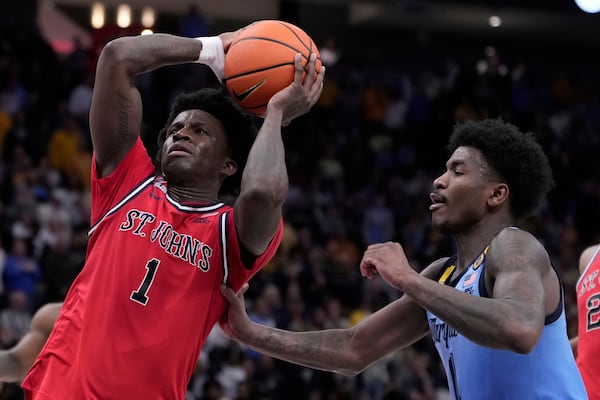 St. John's's Kadary Richmond gets past Marquette's Kam Jones during the second half of an NCAA college basketball game Saturday, March 8, 2025, in Milwaukee. (AP Photo/Morry Gash)