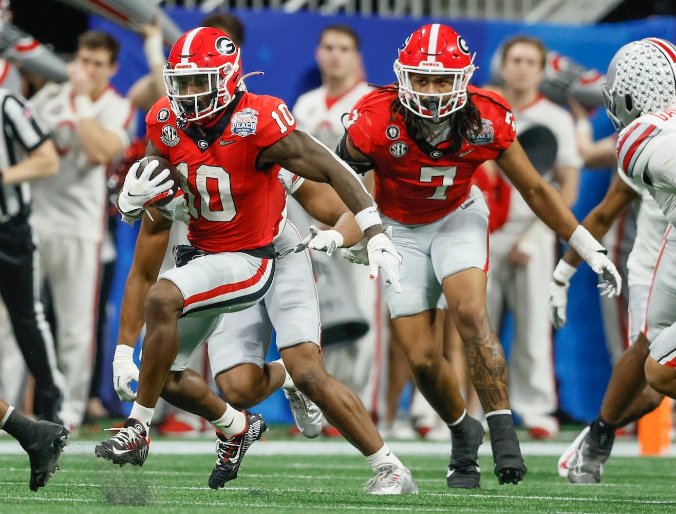 Georgia Bulldogs wide receiver Kearis Jackson (10) returns a fourth quarter kickoff following an Ohio State field goal during the fourth quarter of the College Football Playoff Semifinal between the Georgia Bulldogs and the Ohio State Buckeyes at the Chick-fil-A Peach Bowl In Atlanta on Saturday, Dec. 31, 2022.  Georgia won, 42-41. (Jason Getz / Jason.Getz@ajc.com)