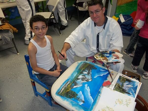 John Turner with his godson, Xavier Jennings, when Turner was still an inmate at Walker State Prison. Walker State Prison has an art program that Turner helped start. (Family photo.)