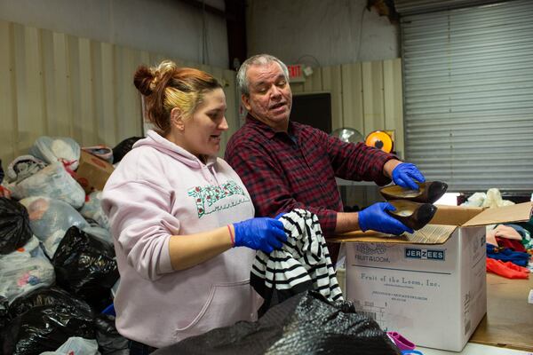 Sweetwater Mission volunteers Tori Sokol and Chuck Stowers sort clothing in Austell, Georgia, on Monday, Nov. 25, 2019. More than 80,000 people in Cobb County are food-insecure, and with Thanksgiving approaching, community food pantries such as Sweetwater Mission are serving on average 80 people a day. (Photo/Rebecca Wright for the Atlanta Journal-Constitution)