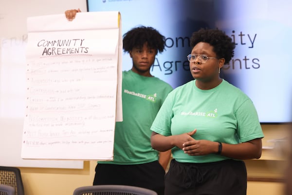 Sustainable Georgia Futures organizer and program manager Ty Wilson speaks during a training session for canvassers at Clark Atlanta, Thursday, October 12, 2023, in Atlanta. Also shown is lead canvaser Drew Barnes. Member of the non-profit are going door to door in some of Atlanta’s most energy-burdened neighborhoods to identify potential participants in the city’s weatherization program to upgrade homes for energy efficiency. (Jason Getz / Jason.Getz@ajc.com)