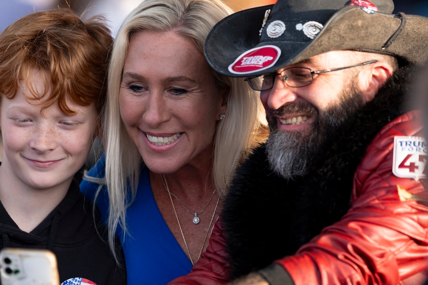 Rep. Marjorie Taylor Greene poses for a photo with fans before a rally for former President Donald Trump in Macon on Sunday, Nov. 3, 2024.   Ben Gray for the Atlanta Journal-Constitution