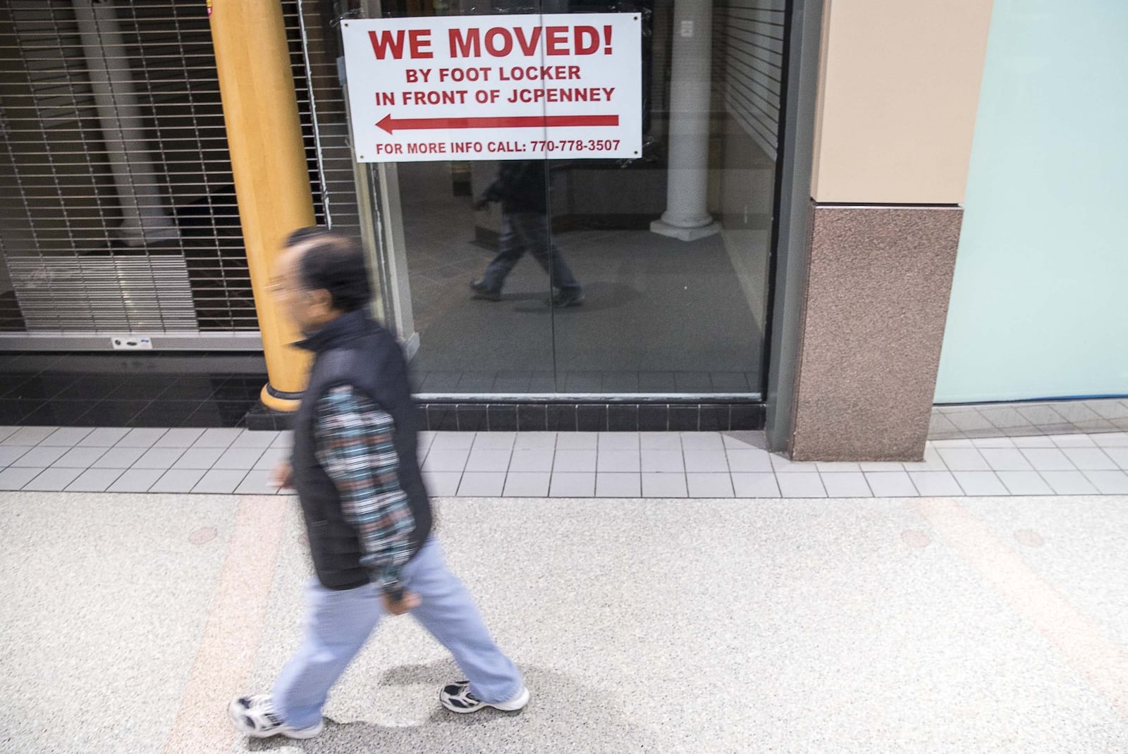 A man walks past an empty storefront inside Northlake Mall in Tucker during the 2019 holiday shopping season. (ALYSSA POINTER/ALYSSA.POINTER@AJC.COM)