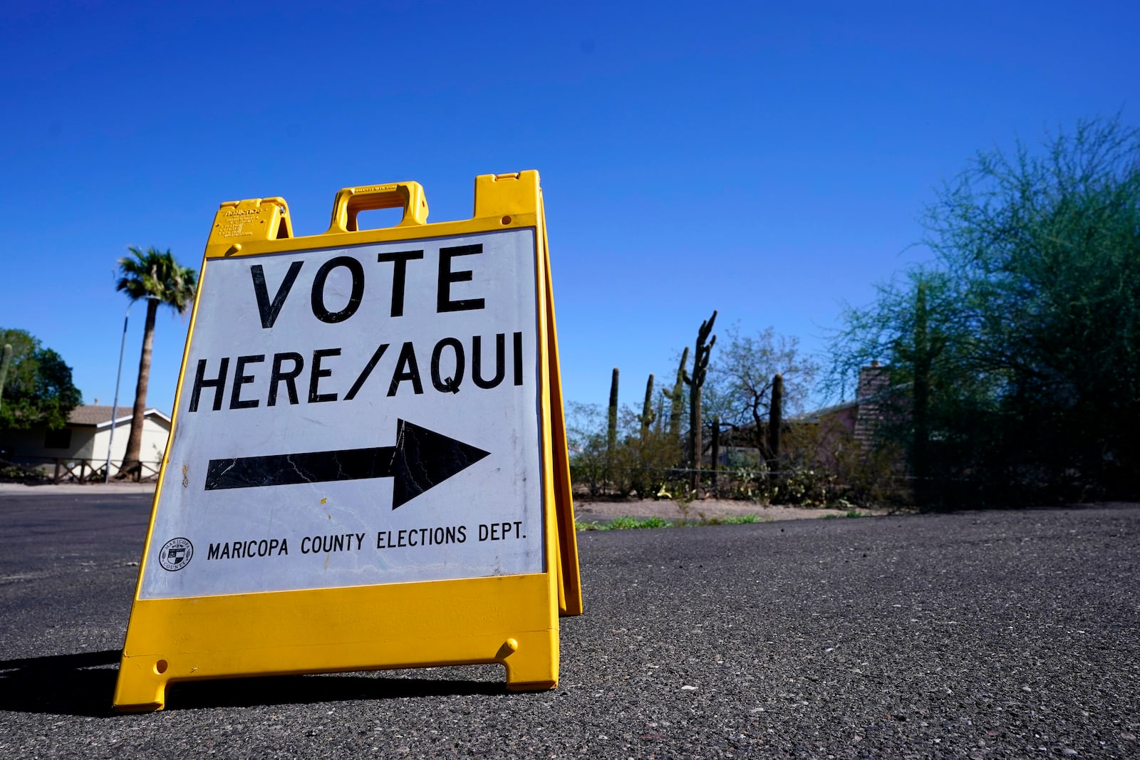 FILE - A sign marks the entrance to a voting precinct on the first day of early voting in the general election in Phoenix, Oct. 12, 2022. (AP Photo/Ross D. Franklin, File)